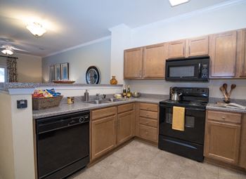 Black, energy efficient appliances in your kitchen at Hawthorne at Horse Pen Creek